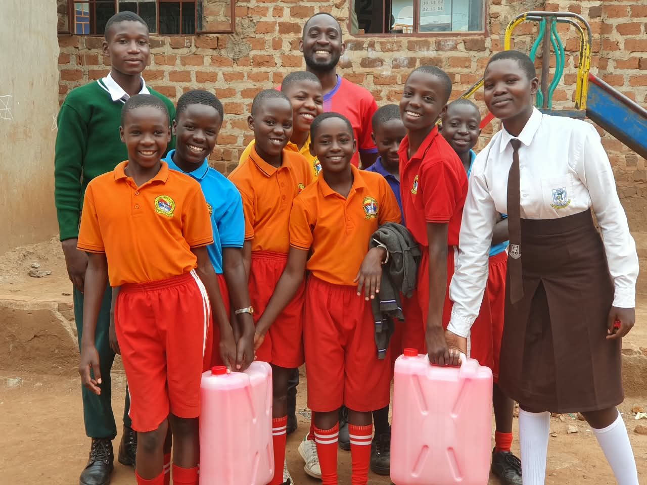 Ssaku SSS Interact Club students with primary school pupils and donated liquid soap